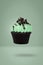 Mint cupcake flying on green background, idea minimal concept for new year and christmas holliday