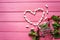 Mint gum in the shape of a heart, mint and a small truck on a pink wooden background