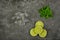 Mint leaves, lime slices and ice cubes on table