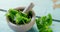 Mint leaves with mortar and pestle on wooden table 4k