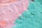 Mint pink concrete wall in paint as background closeup