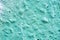 Mint pink concrete wall in paint as background closeup