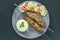 Minted lamb kebabs on skewers with rice and salad