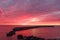 Miraculous colorful sunrise width cloudy sky on the cost of the Baltic Sea. Estonia. Abruka