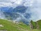 Miraculous low clouds and a mystical fog of the mountain range First and in the Schwyz Alps mountain massif, Oberiberg