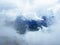 Miraculous low clouds and a mystical fog of the mountain range First and in the Schwyz Alps mountain massif, Oberiberg