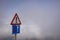 Mirador del Rio - Lanzarote:  Isolated warning sign fÃ¼r one way traffic above clouds Focus on left sign