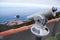 Mirador viewpoint with telescope for watching at beautiful view of cape with Garachico town. Northern part of Tenerife island.