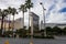 The Mirage hotel and casino along the Las Vegas strip with lush green palm trees, people walking along the sidewalk