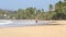 MIRISSA, SRI LANKA - MARCH 2014: Man standing in the waves washing up on shore in Mirissa. This small sandy tropical beach boasts