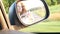 Mirror of a driving car view and reflection of a young girl,