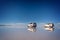 Mirror effect and reflections of 4x4 cars in Salar de Uyuni Uyuni salt flats, Potosi Bolivia, South America