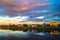 Mirror glossy surface of the Volga river reflects dramatic sunset sky. City of Tver, Russia.