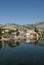 Mirror image of the old buildings in the town of Trebinje, Bosnia and Herzegovina in the water of the river