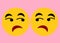 A mirror image of a pair of smiley emoticons of dislike disbelief detest expression light pink backdrop