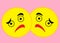 A mirror image of two yellow face expression smiley emoticons of despair and disgusted disappointment light pink backdrop