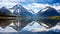 Mirror Lake Reflecting Mountain Majesty under Blue Sky and Clouds