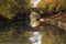 Mirror Reflection of Arched Bridge and autumn Trees in the Grand Union Canal