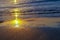 MIrror reflection of dawn on wet sand