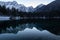 Mirror reflection mountain in beautiful fusine lakes in julian alps in dusk blue hour, italy