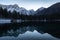 Mirror reflection mountain in beautiful fusine lakes in julian alps in dusk blue hour, italy