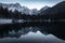 Mirror reflection mountain in beautiful fusine lakes in julian alps in dusk blue hour, italy