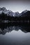 Mirror reflection mountain in beautiful fusine lakes in julian alps in dusk blue hour, italy