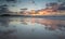 Mirrored coastal reflections in wet beach sand at sunrise