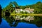 Mirroring house in lake, green trees and blue sky and water, on Hilton Head Island