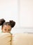 Mischievous African girl hiding behind sofa