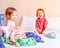 Mischievous Brother and Sister Play in a Pile of Laundry on the Bed. Family Concept.