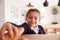 Mischievous Girl Wearing School Uniform Taking Croissant From Kitchen Counter