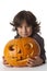 Mischievous Little boy with a Halloween pumpkin