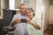 Mischievous senior couple taking selfie in kitchen