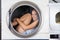 Mischievous Woman Sitting Inside Washing Machine