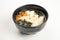 Miso soup with seafood in a black karelka. Ingredients broth, shrimp, salmon, perch, Tofu cheese, nameko mushrooms, miso paste,