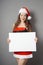 Miss santa presenting blank sign with copy space