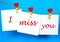 Miss you text on stickers hanging on heart shape pins
