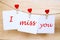 Miss you text on stickers hanging on heart shape pins