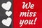 We miss you type message on red plush material and hearts