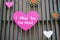 Miss you written on a pink heart on a wall