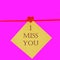 Miss you written with wooden letters next red wooden heart