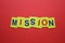 Mission inscription in yellow letters on a red background