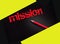 Mission word in yellow on black  and pencil on a dark background. Business concept