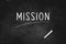 Mission written with chalk on blackboard icon logo design vector illustration