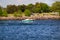 MISSISSAUGA, CANADA - 06 10 2020: A green and white motorboat with Canadian flag gliding in the waters of Lake Ontario