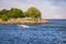 MISSISSAUGA, CANADA - 06 10 2020: A motorboat gliding in the waters of Lake Ontario in front of people having rest at