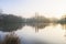 Mist across a lake thins as the rising sun warms up the land