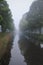 Mist covering the city channel in Breda giving mysterious white and grey landscape