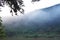 Mist floating cover banana tree and mountain beside river